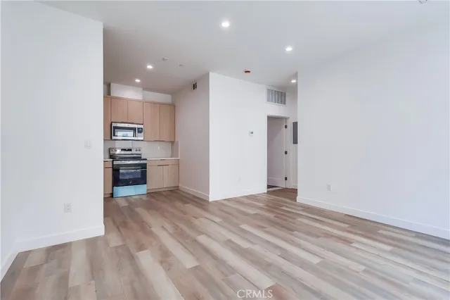 a view of kitchen with cabinets and wooden floor