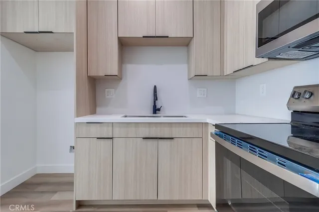 a kitchen with stainless steel appliances granite countertop a sink stove and cabinets