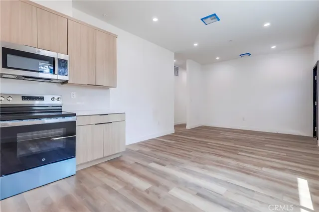 a view of a kitchen with stove and microwave