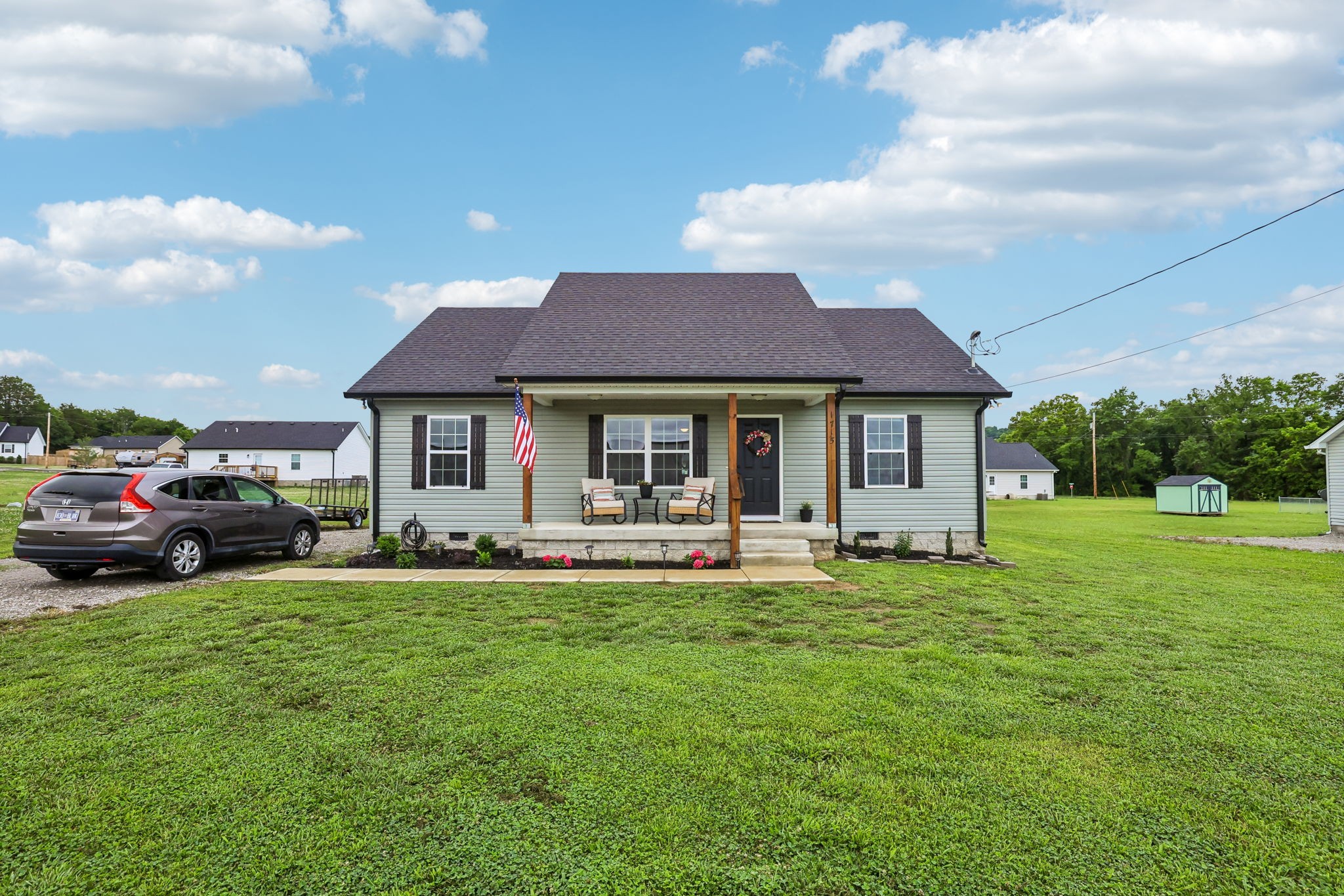 1715 Old Belfast Road Lewisburg, TN 37091 - Photo 2 of 42 a front view of a house with a garden and trees