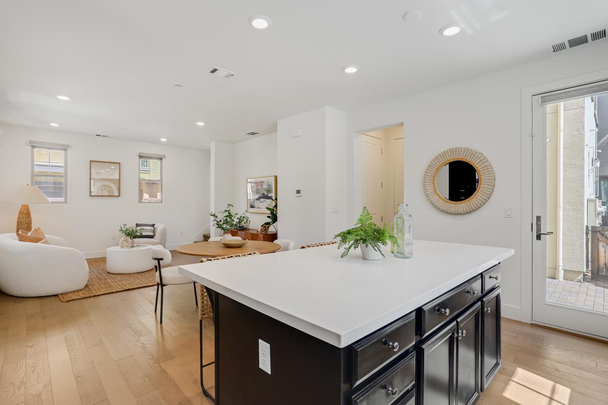 14 Catania Common Fremont, CA 94536 - Photo 16 of 39 a living room with kitchen island a table and chairs