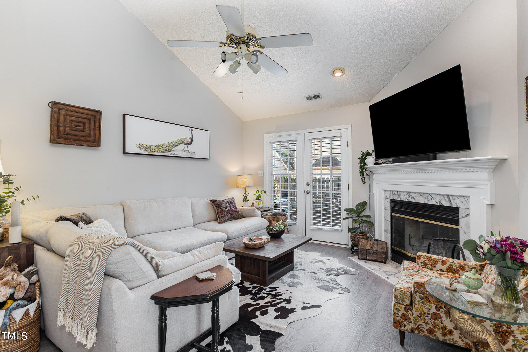 12109 Queensbridge Court Raleigh, NC 27613 - Photo 7 of 21 a living room with furniture a fireplace and a flat screen tv