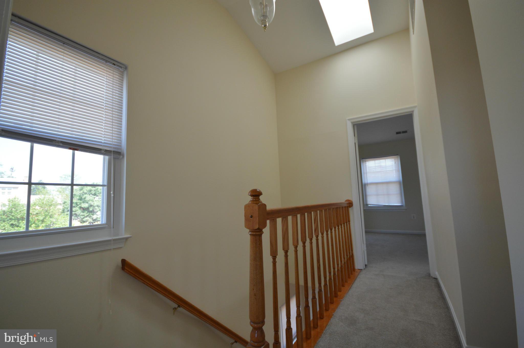 12333 Sandy Point Court Silver Spring, MD 20904 - Photo 14 of 30 Upper level stairs with skylight in hallway