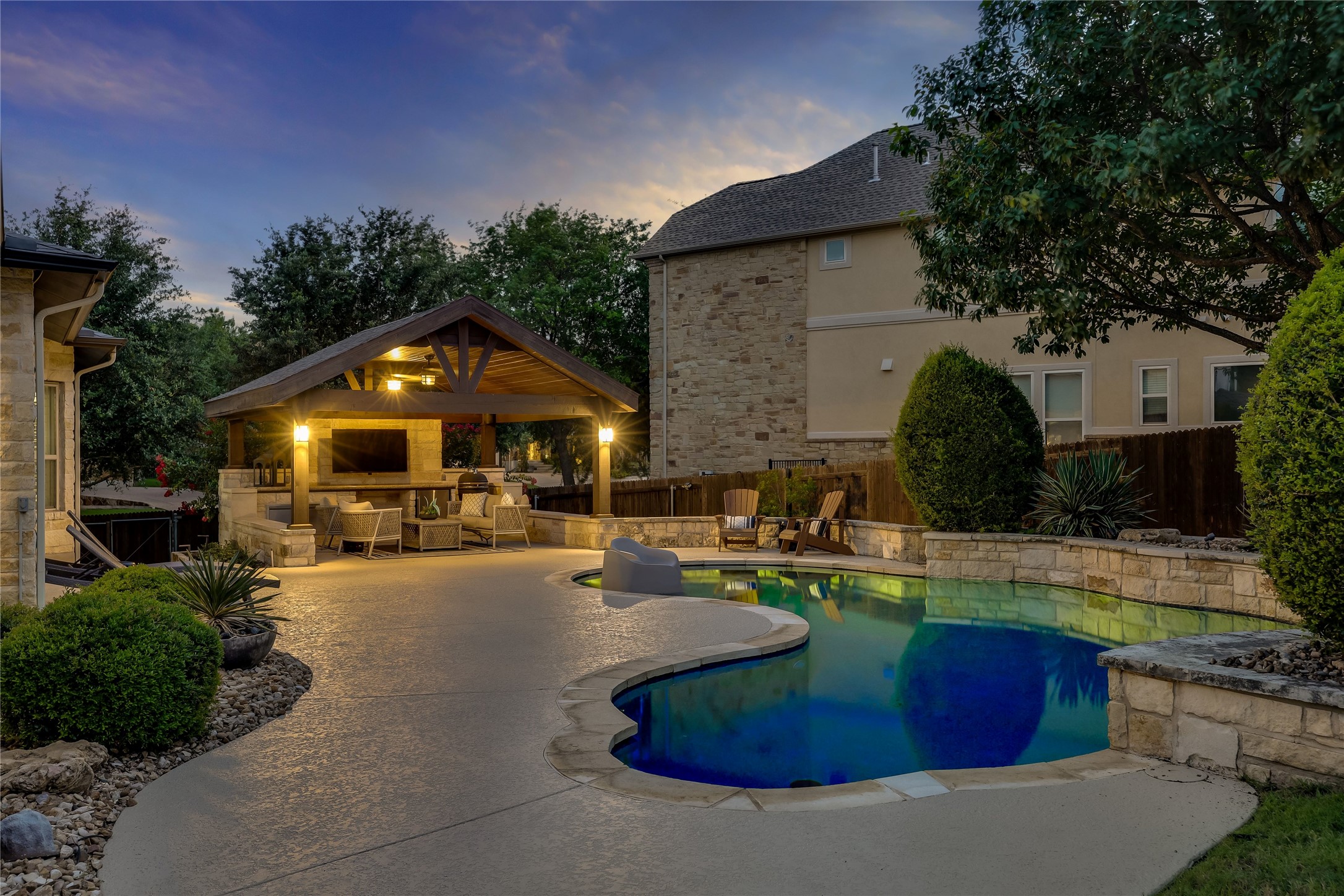 401 Bluff View Road Cedar Park, TX 78613 - Photo 16 of 40 An inviting backyard oasis offers a free-form pool and a fully equipped outdoor kitchen under a charming gazebo.