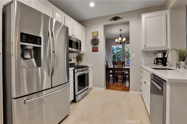 a kitchen with stainless steel appliances a refrigerator stove and microwave