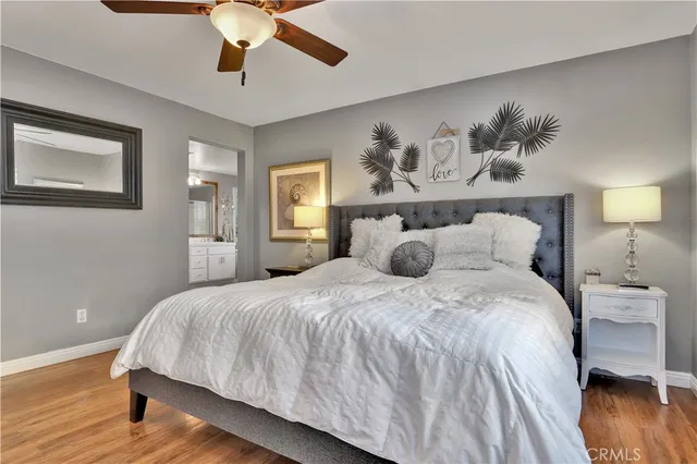 a large bed sitting in a bedroom and a chandelier