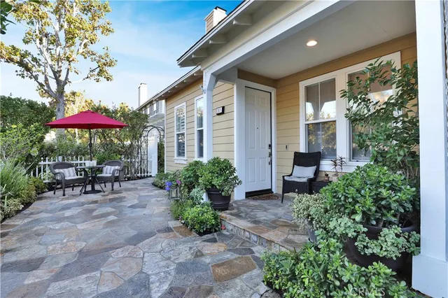 a view of a patio with a table and chairs under an umbrella