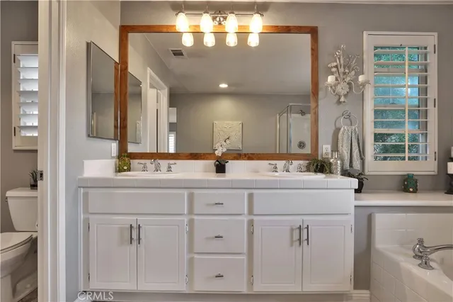 a bathroom with a sink vanity and mirror
