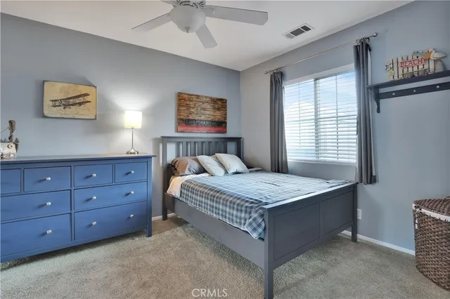 a bedroom with a bed and a dresser in it