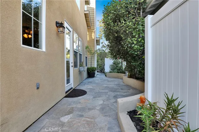 a view of a house with a yard and potted plants