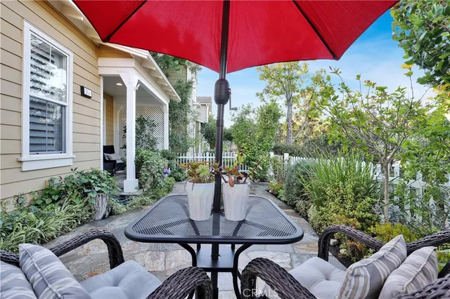 a view of a patio with table and chairs under an umbrella