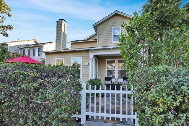 a front view of a house with yard and fountain