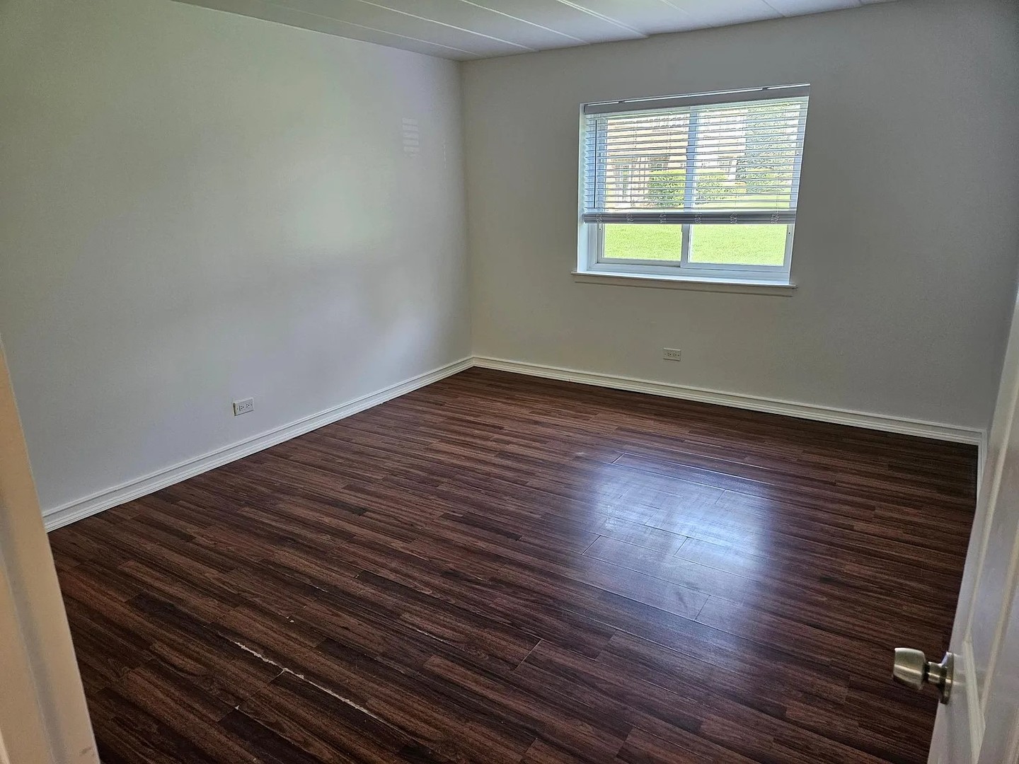 300 South Roselle Road, Unit 111 Schaumburg, IL 60193 - Photo 8 of 13 a view of an empty room with wooden floor and a window