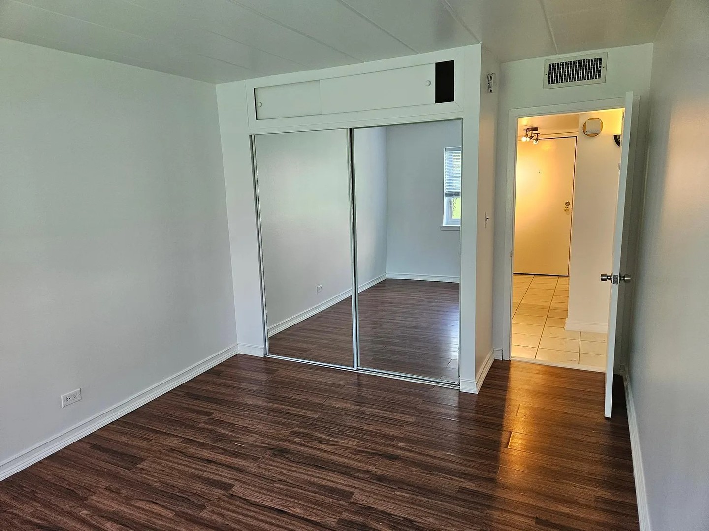 300 South Roselle Road, Unit 111 Schaumburg, IL 60193 - Photo 10 of 13 a view of empty room with wooden floor and a window