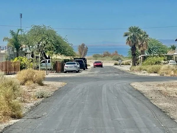 a view of street with parked cars