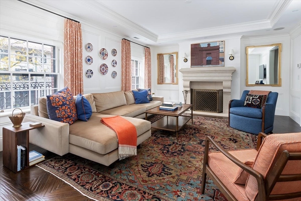 a living room with furniture fireplace and window