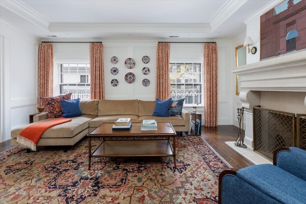142 Chestnut Street, Unit 89 Boston, MA 02108 - Photo 2 of 16 a living room with furniture and a fireplace