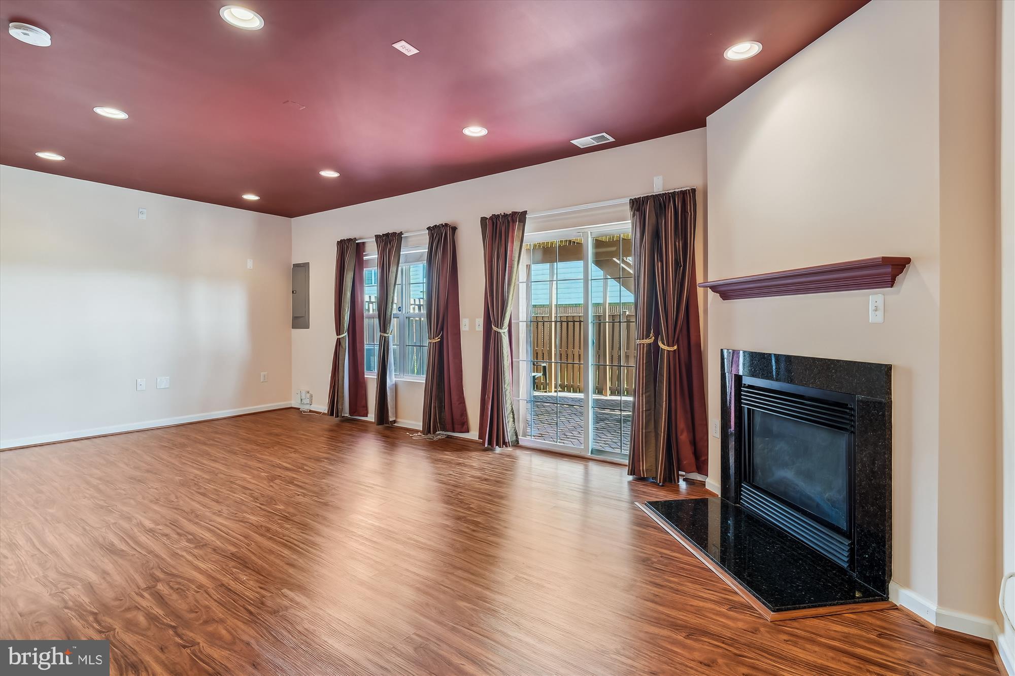 43536 Gabriel Square Chantilly, VA 20152 - Photo 25 of 53 a view of an empty room with wooden floor fireplace and a window