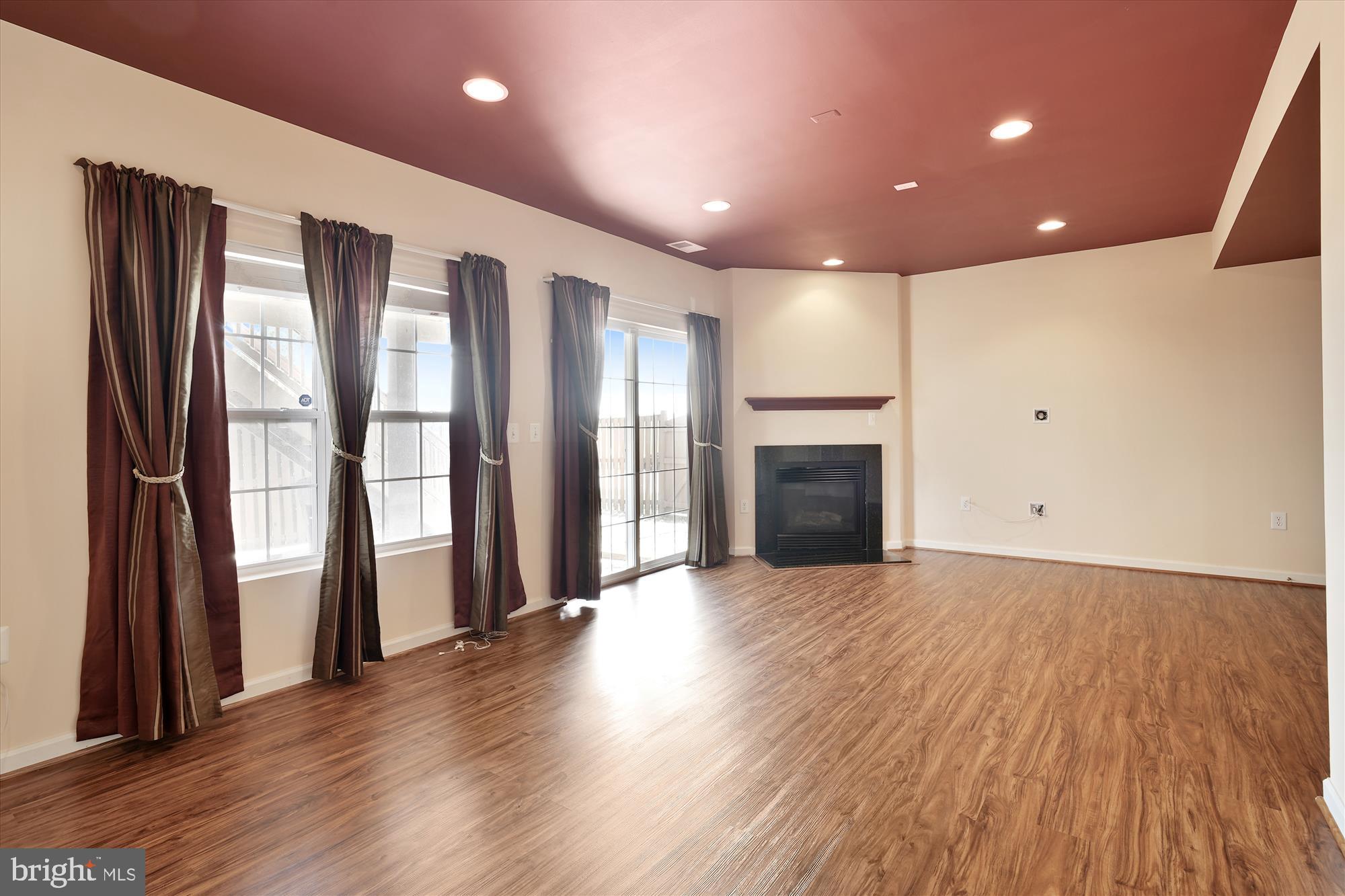 43536 Gabriel Square Chantilly, VA 20152 - Photo 26 of 53 an empty room with wooden floor and fireplace