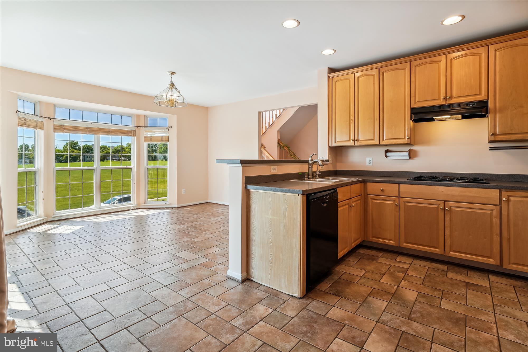 43536 Gabriel Square Chantilly, VA 20152 - Photo 6 of 53 a kitchen with a stove sink and cabinets