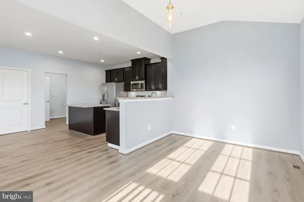 a view of kitchen with microwave and cabinets