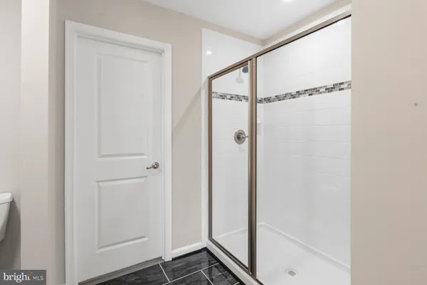 a bathroom with a glass shower door