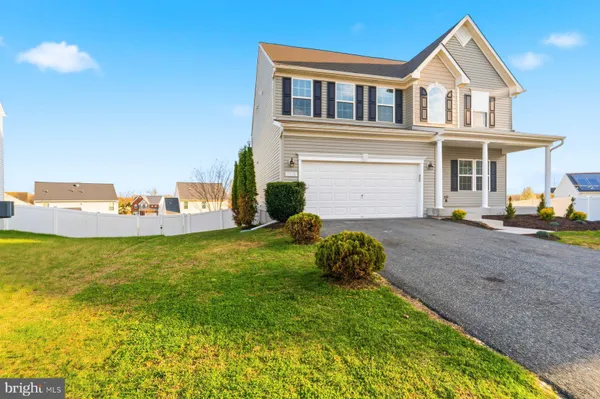 a view of a house with a yard and garage