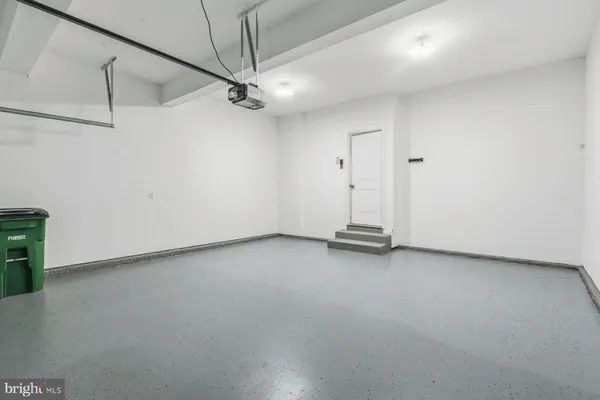 an empty room with a ceiling fan and a window