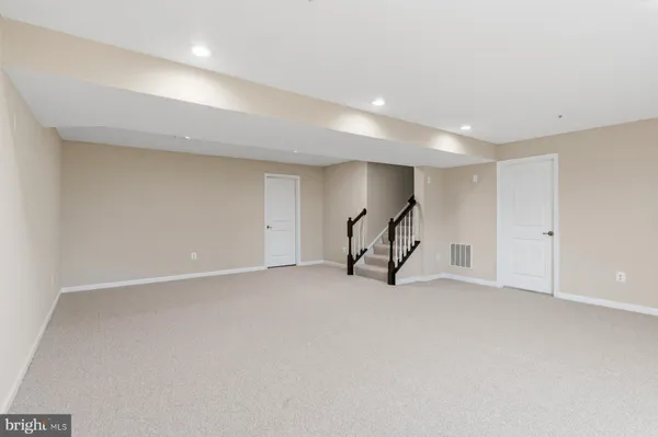 an empty room with a ceiling fan and a window