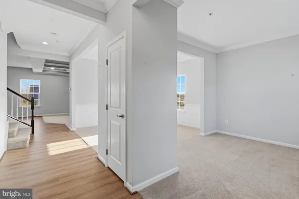 a view of hallway with wooden floor