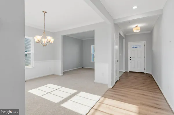 a view of a chandelier fan and entryway