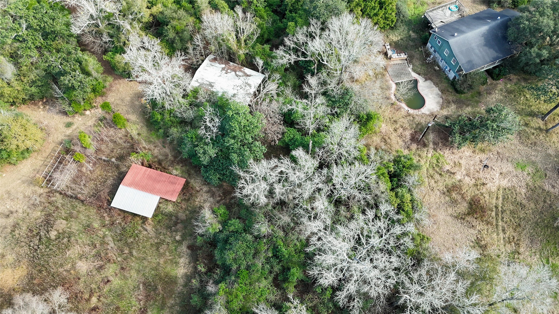 19895 Scott Gardner Road New Caney, TX 77357 - Photo 2 of 11 an aerial view of a house with a yard and a large tree