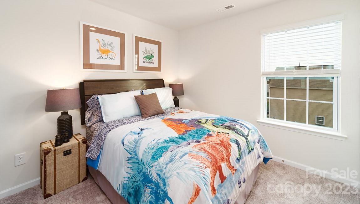 4115 Village Boulevard Northwest Conover, NC 28613 - Photo 20 of 22 a bedroom with a bed and wooden floor