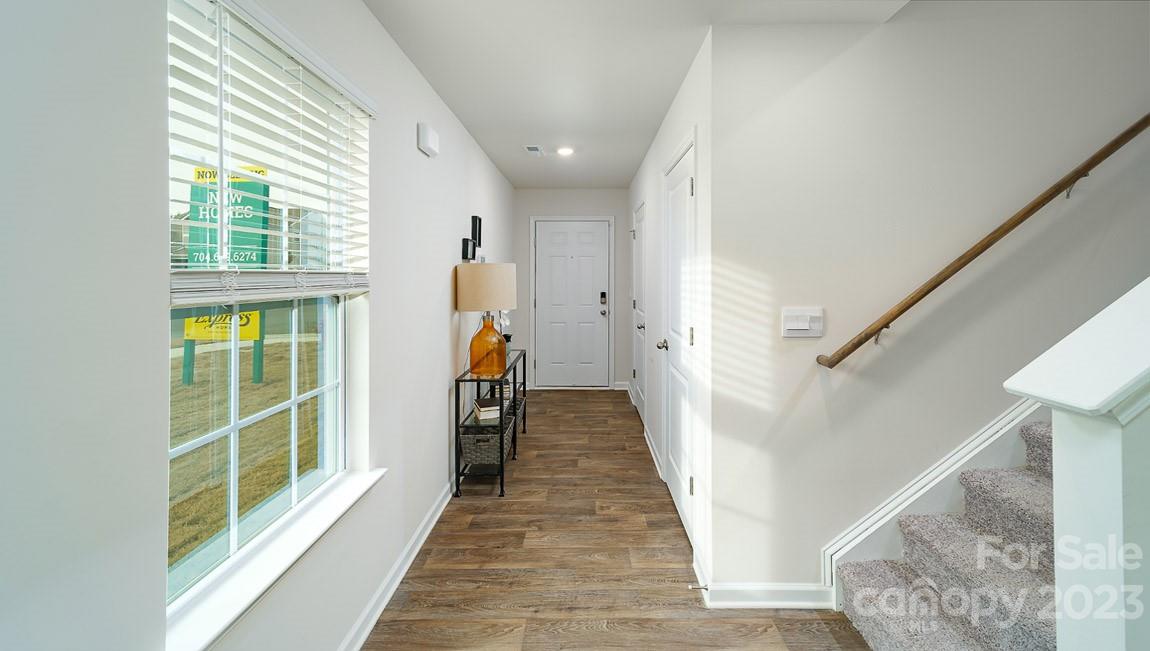 4115 Village Boulevard Northwest Conover, NC 28613 - Photo 2 of 22 a view of a hallway with wooden floor and staircase
