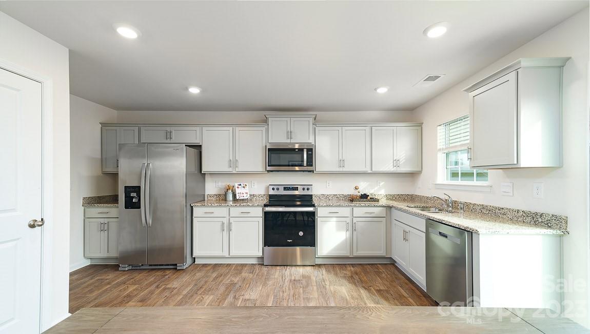 4115 Village Boulevard Northwest Conover, NC 28613 - Photo 8 of 22 a large kitchen with cabinets stainless steel appliances and a window