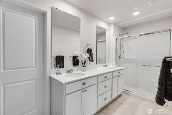 a bathroom with a sink double vanity and a mirror