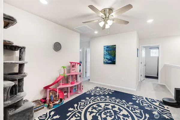 a bedroom with furniture and a chandelier fan