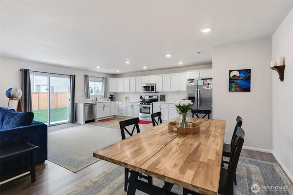 a view of a dining room with furniture and wooden floor