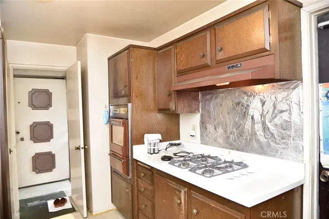 a kitchen with a stove a sink and a refrigerator