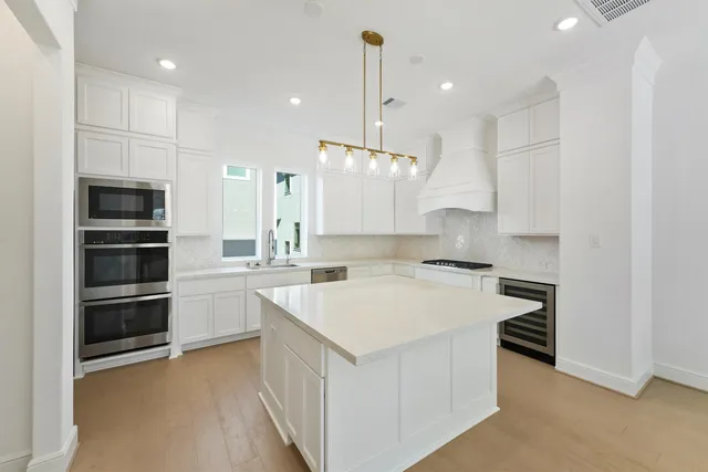 a kitchen with a refrigerator and a sink