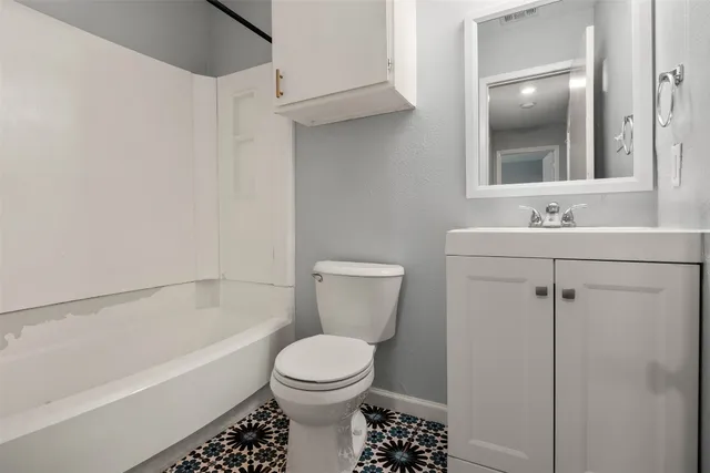 a bathroom with a toilet sink and bathtub