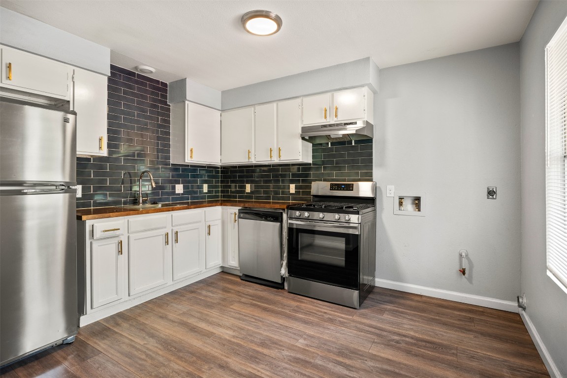 7004 Circle S Road, Unit A Austin, TX 78745 - Photo 2 of 16 a kitchen with stainless steel appliances granite countertop a stove a sink and a refrigerator