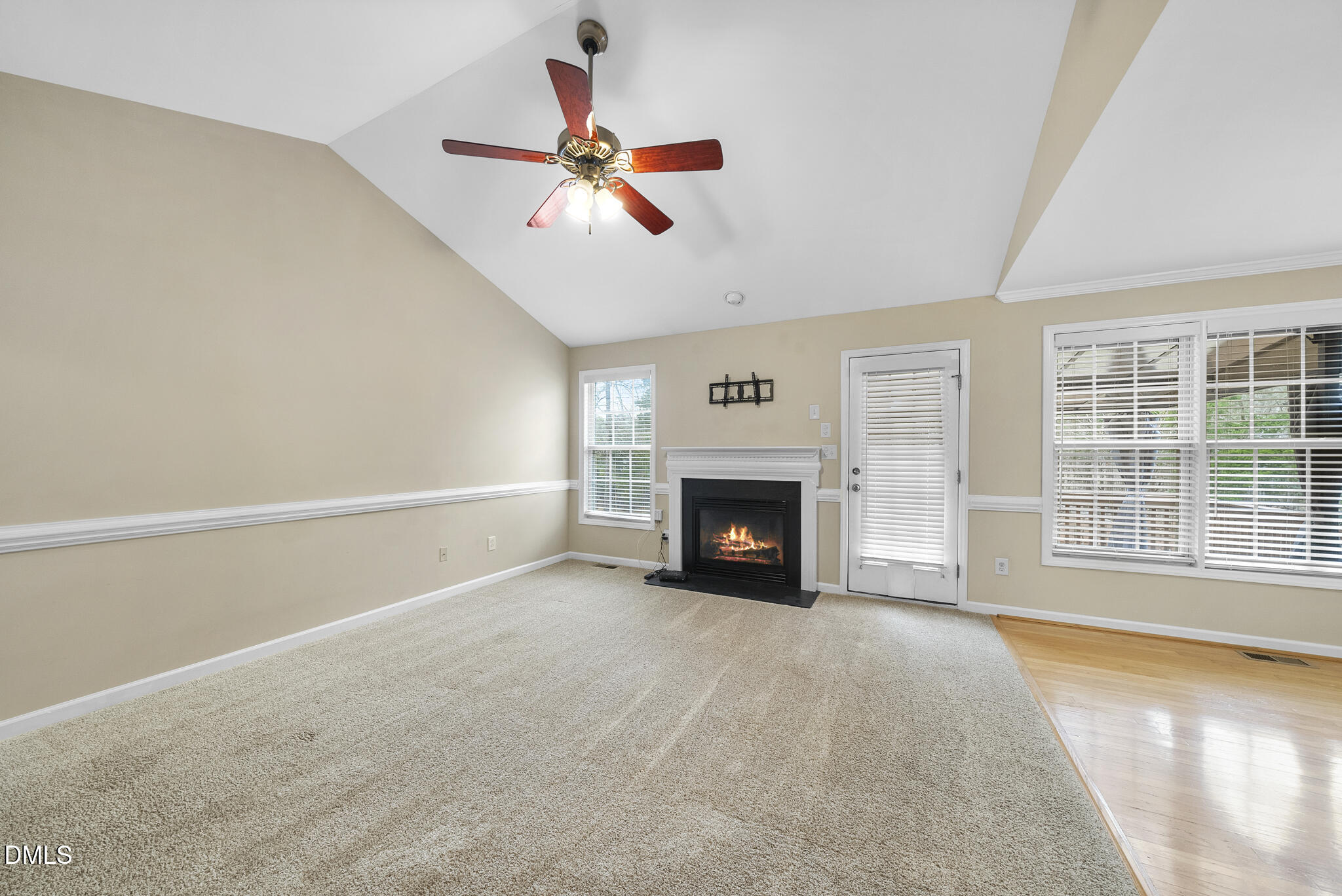 6 Stone Mill Place Durham, NC 27712 - Photo 6 of 44 a view of an empty room with a fireplace and a window