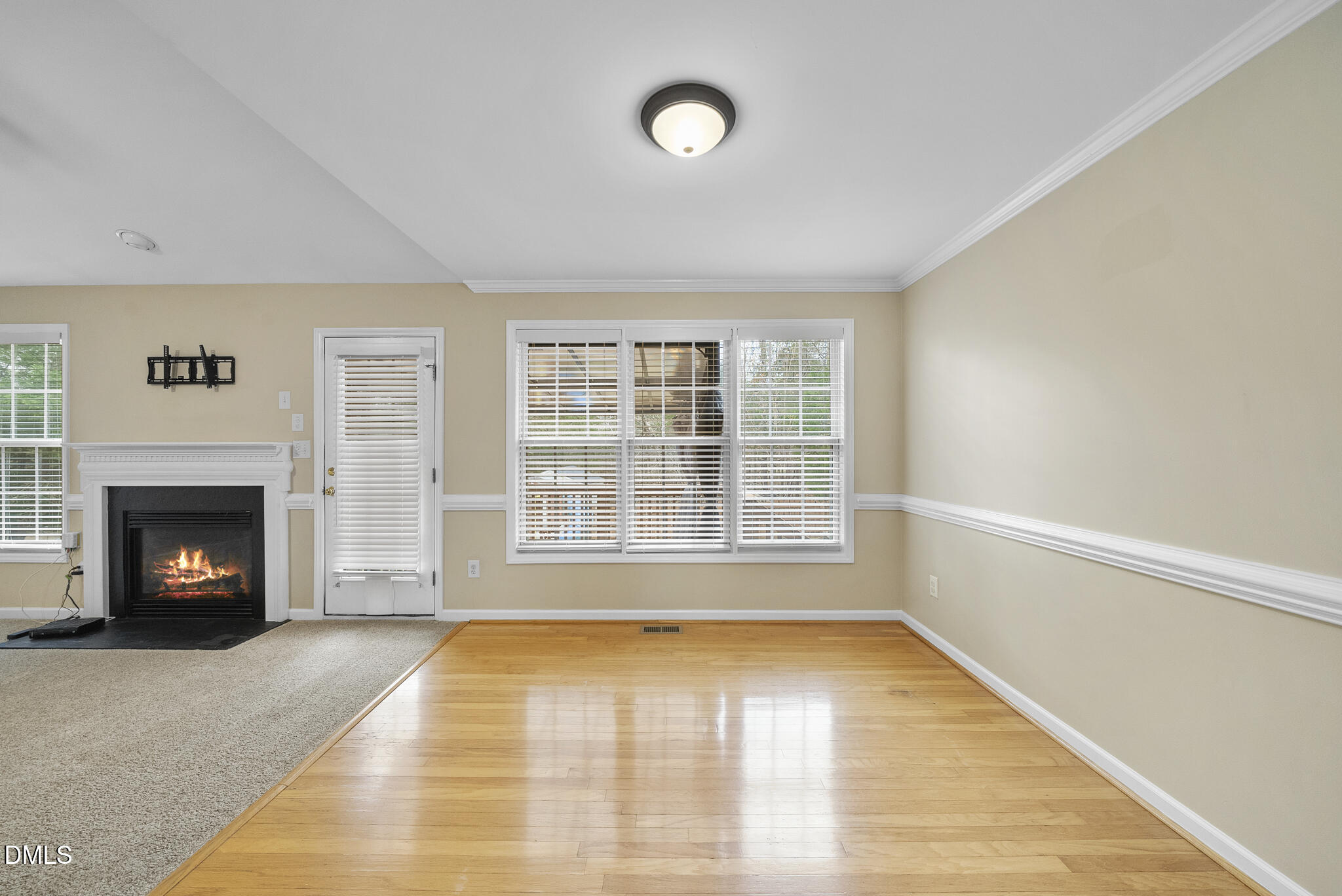 6 Stone Mill Place Durham, NC 27712 - Photo 8 of 44 a view of an empty room with a fireplace and a window