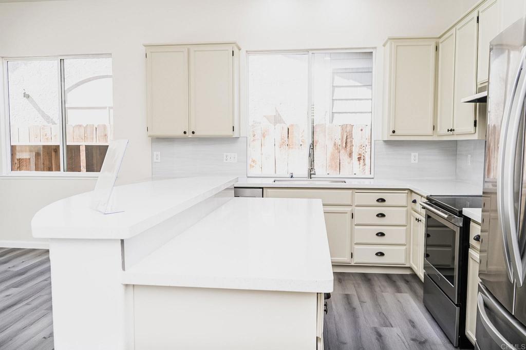 3005 Litt Road Modesto, CA 95355 - Photo 17 of 53 a kitchen with cabinets appliances and a wooden floor