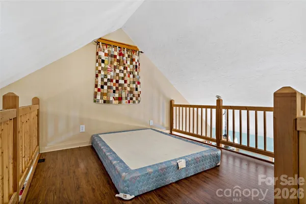a bed sitting in a bedroom next to a window