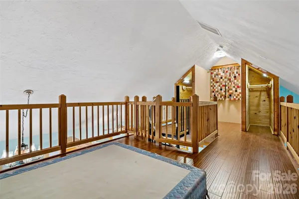 a view of walk in closet with wooden floor