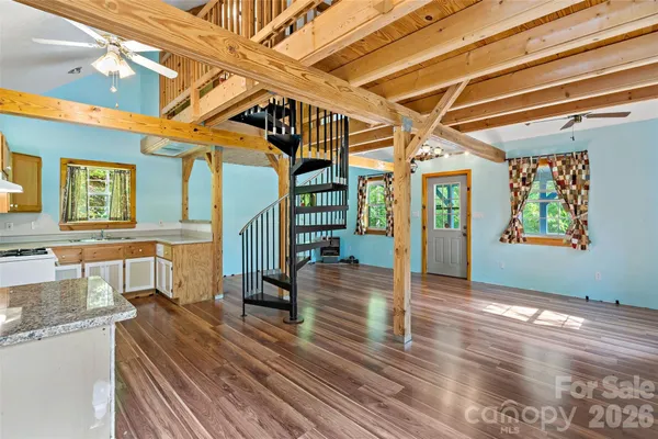 a view of a room with window and stairs