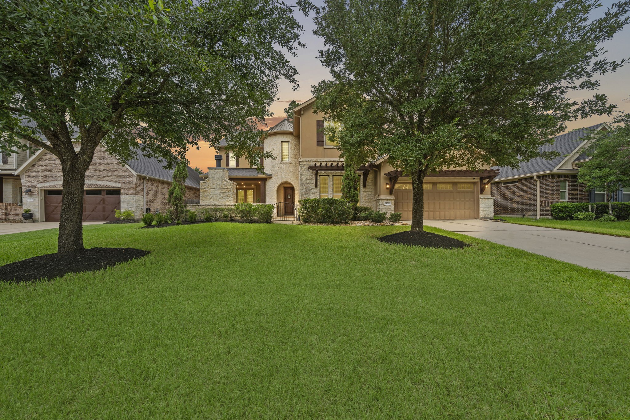 14215 Spindle Arbor Road Cypress, TX 77429 - Photo 1 of 47 This is a beautiful two-story home with a stone and stucco facade, featuring a well-maintained lawn and mature trees. It has a welcoming driveway leading to a two-car garage and a charming entryway.