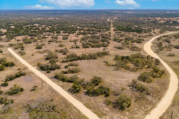 a view of a lake with a tree in the background